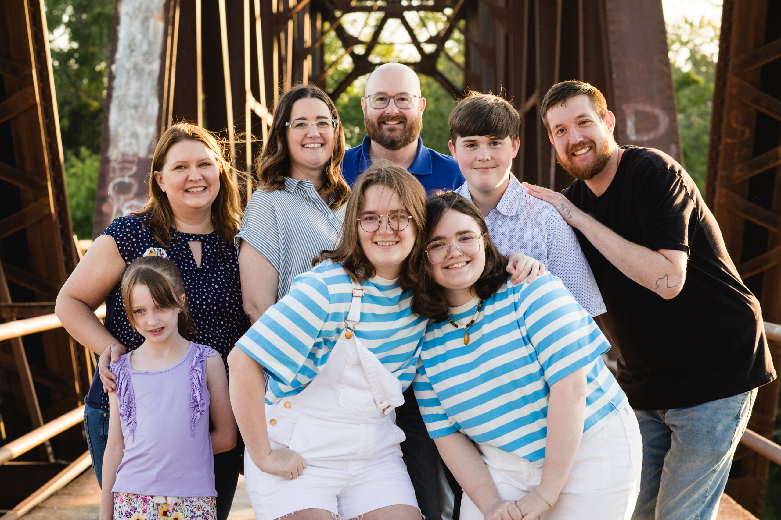 Extended family photo outdoors on a bridge