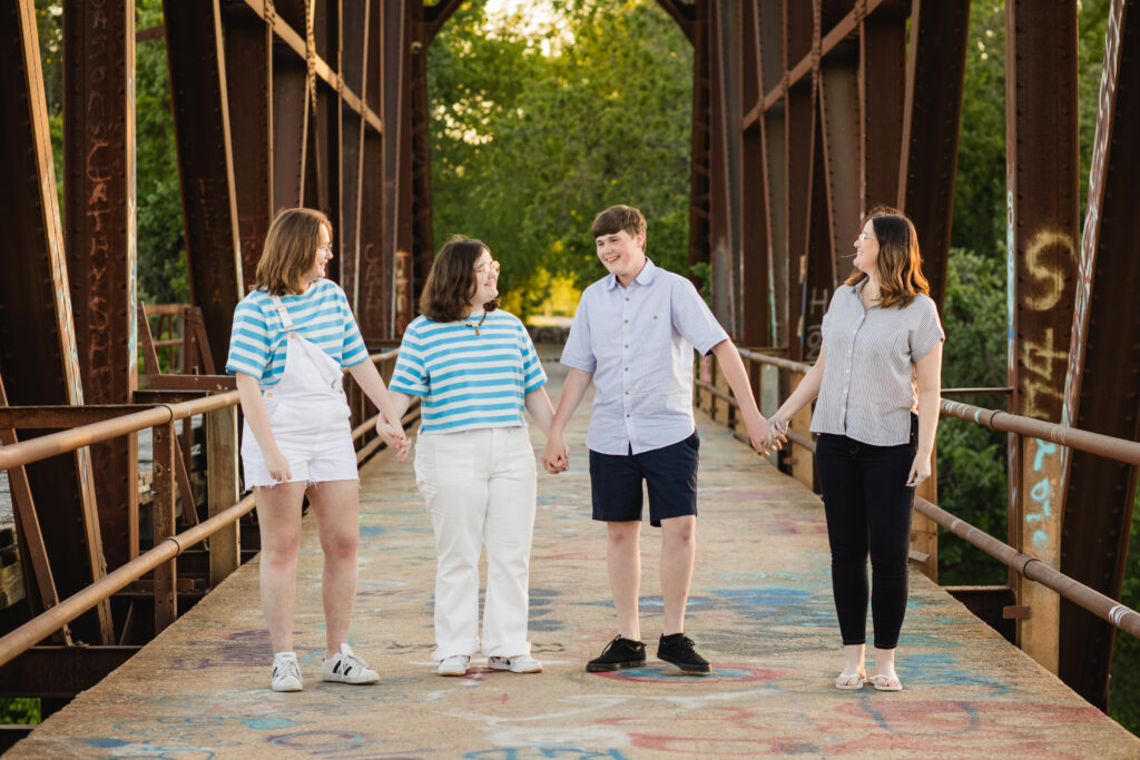 Family photo outdoors on a bridge