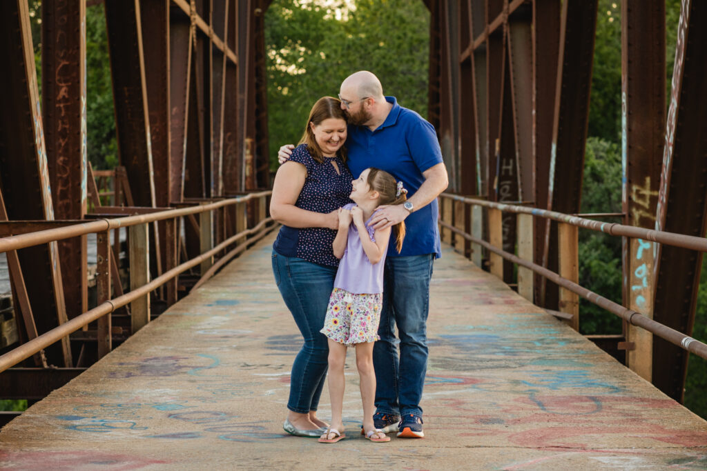 Family photo outdoors on a bridge