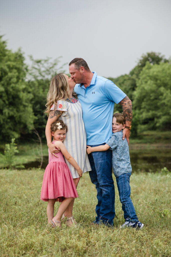 Outdoor North Texas family photos in a pasture; two kids