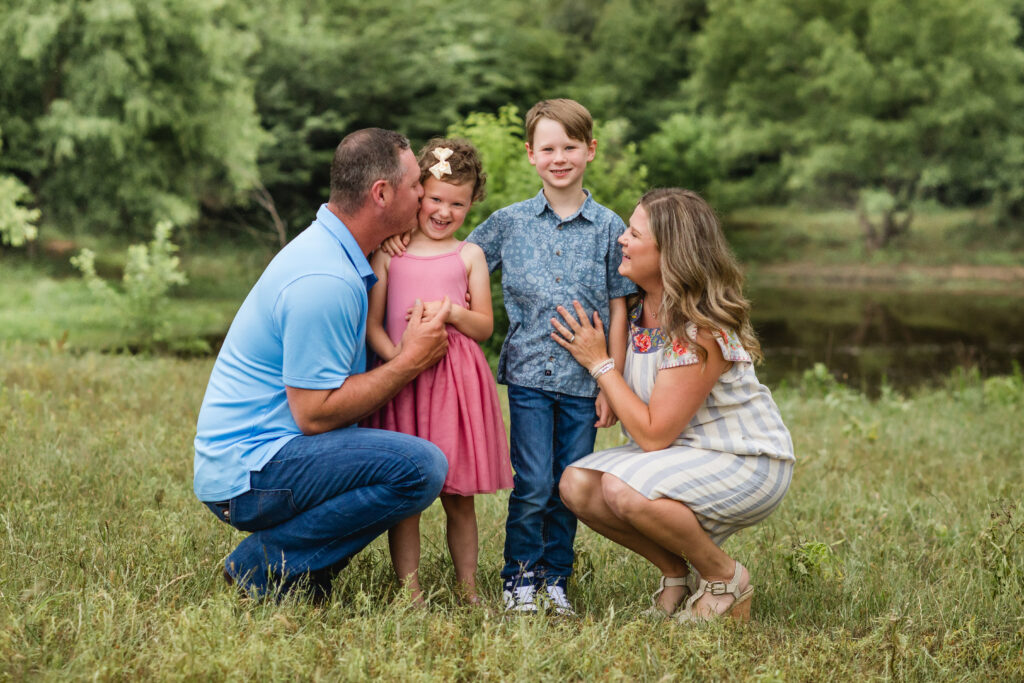 Outdoor North Texas family photos in a pasture; two kids