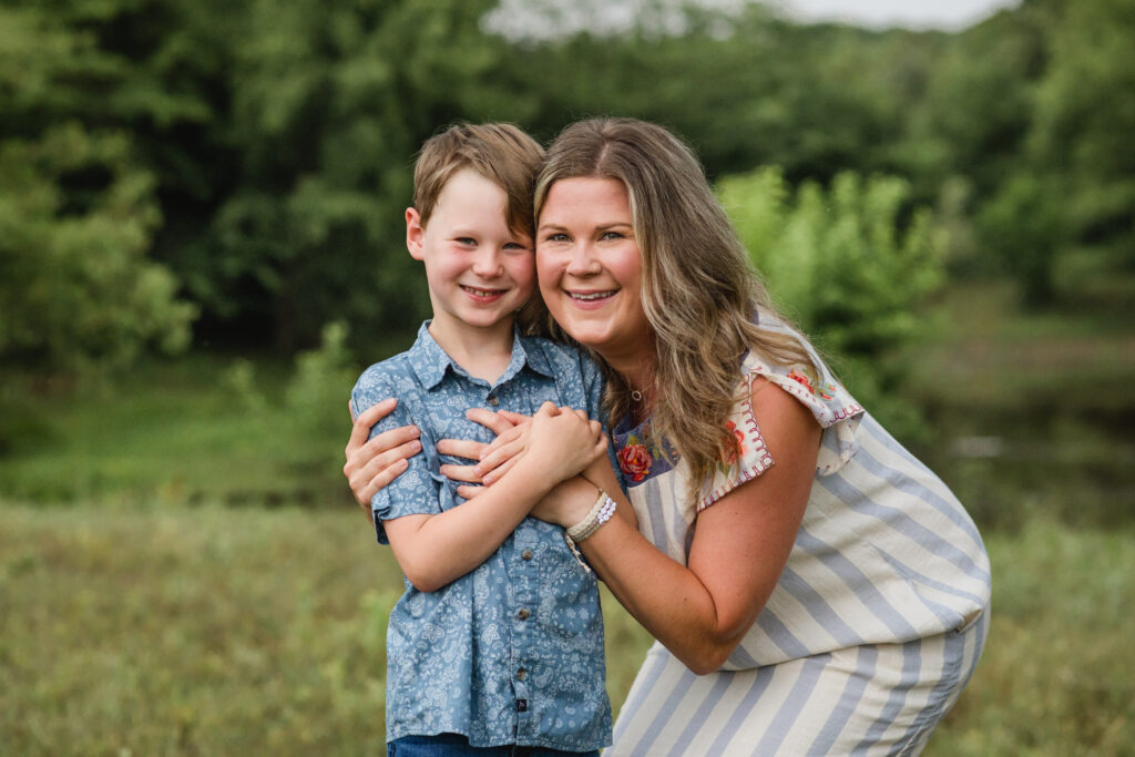 Outdoor North Texas family photos in a pasture; mom and son