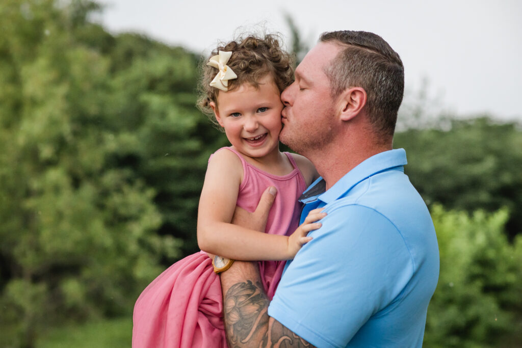 Outdoor North Texas family photos in a pasture; dad and daughter